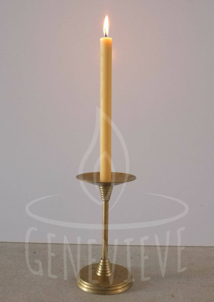 one lit taper on a candlestick